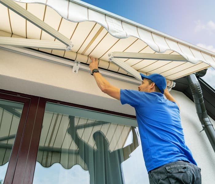man installing awning