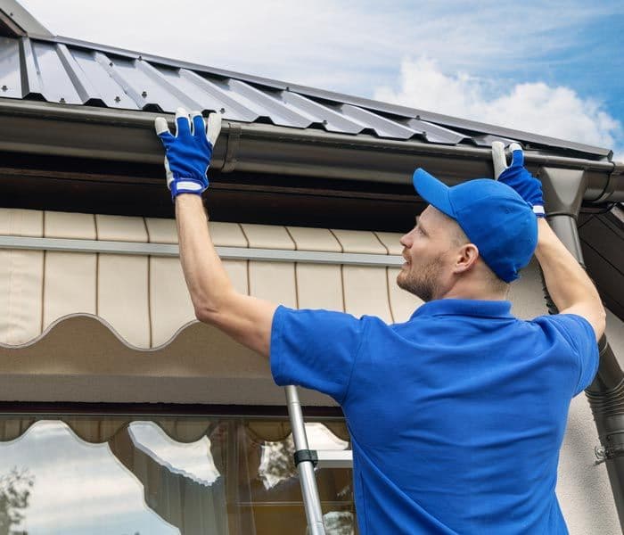 man installing gutters